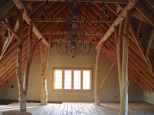 Rustic private artist studio - semi-raw alder tree supports, exposed wood trusses.