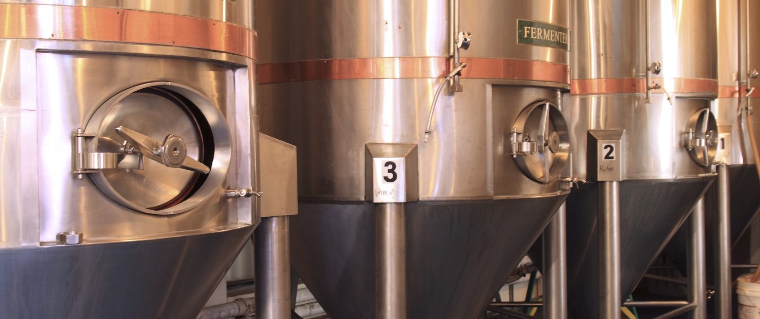 Cobalt blue epoxy floors enhance the beauty of the stainless steel and copper brewery equipment.