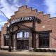 With a nod to Belgian influence on architecture and brewing, design elements include a stepped gable brick front, art-nouveau iron canopy, and exposed steel framed entrance and windows on the building’s exterior.