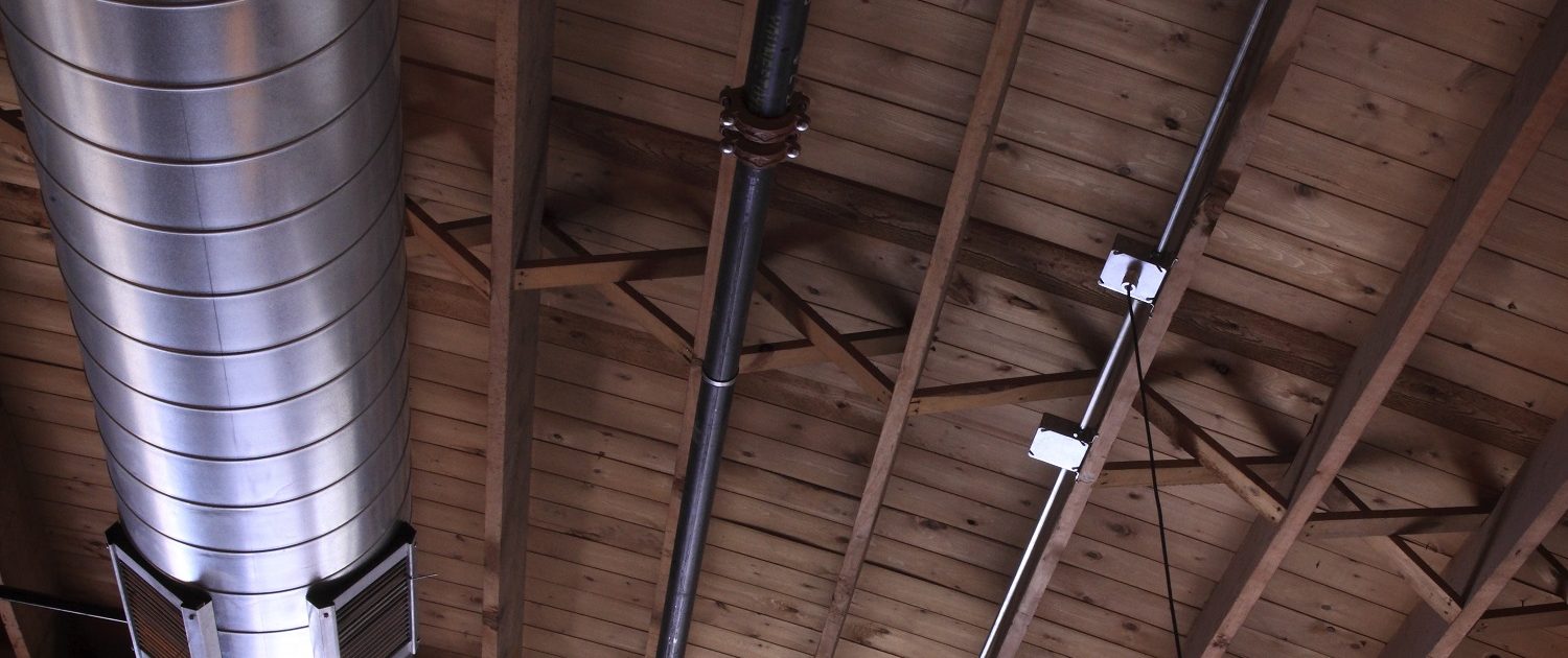 Pizzeria DeVille hidden wood-bowstring trusses exposed during construction.