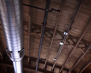 Pizzeria DeVille hidden wood-bowstring trusses exposed during construction.