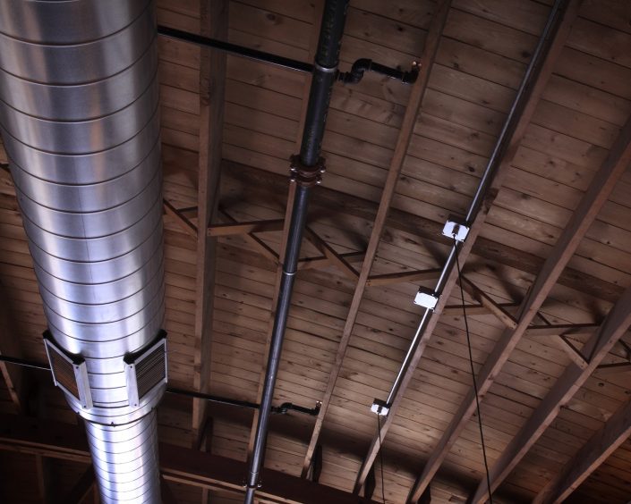 Pizzeria DeVille hidden wood-bowstring trusses exposed during construction.