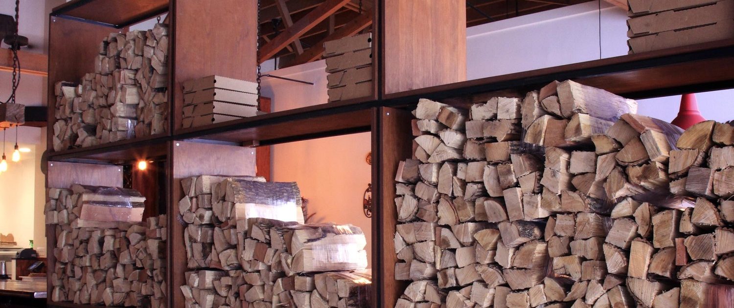 Pizzeria DeVille wood storage element also designed to be a divider between the dining and reception area.