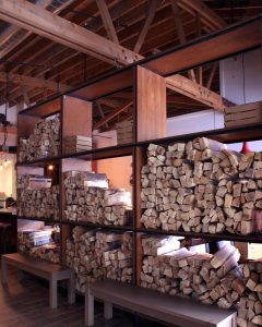 Pizzeria DeVille wood storage element also designed to be a divider between the dining and reception area.