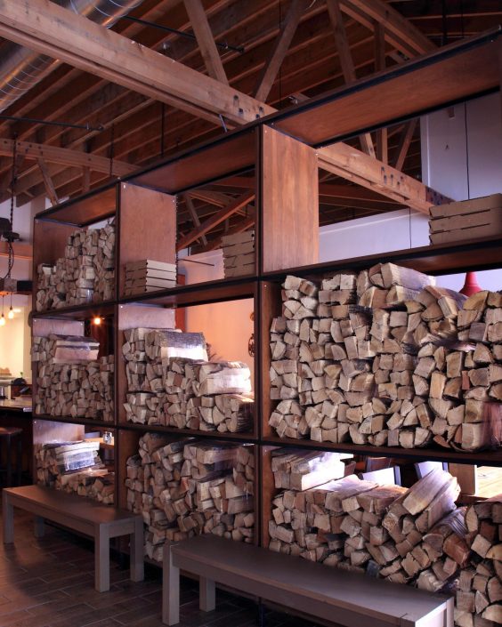 Pizzeria DeVille wood storage element also designed to be a divider between the dining and reception area.