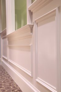 Wide wood wall trim adds emphasis to the traditional brand at State Bank of The Lakes.