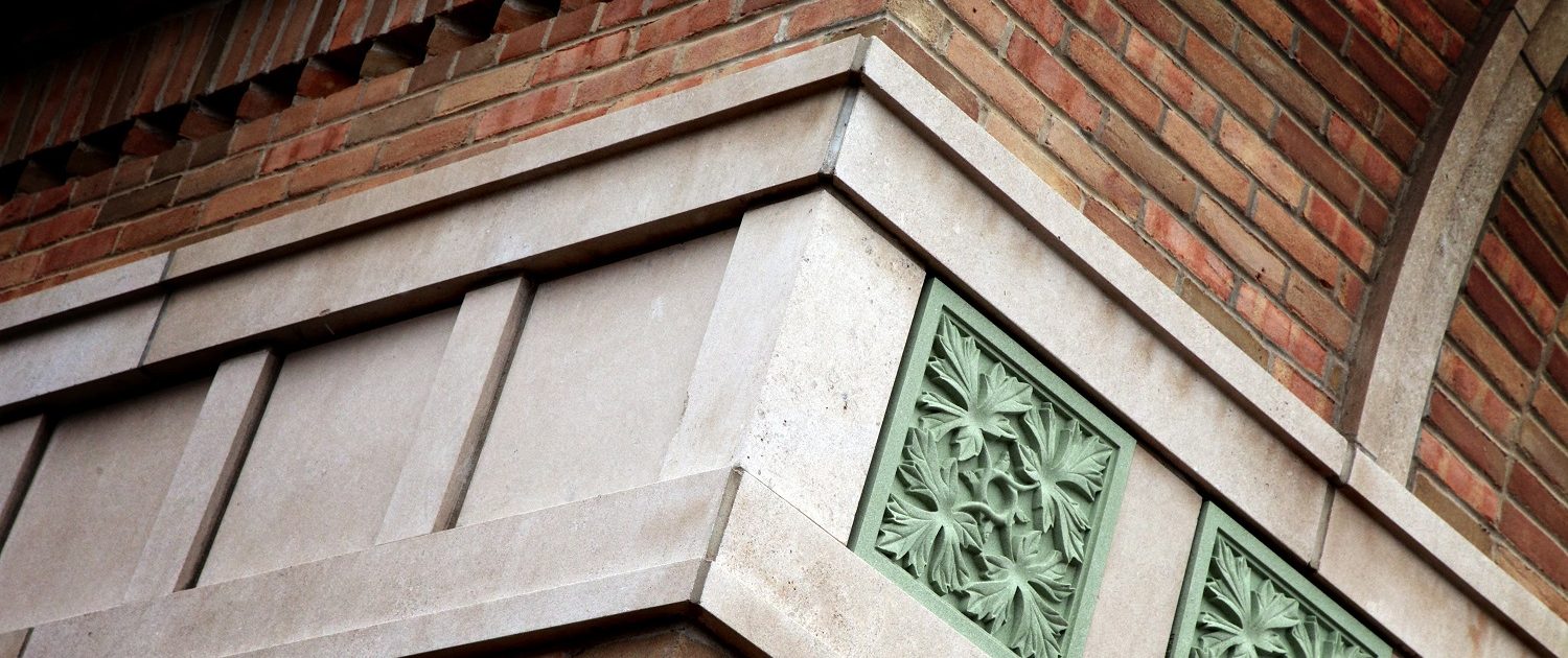State Bank of The Lakes - Round Lake State Bank of The Lakes exterior oak leaf pattern green stone detail and brick & stone masonry.