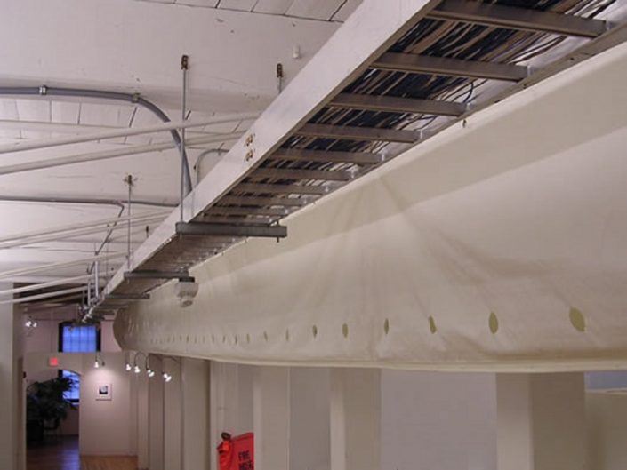 Bleck Design Group Bleck Design Group hi-tech elements included fabric duct work, high efficiency indirect lighting, and a modern product display gallery