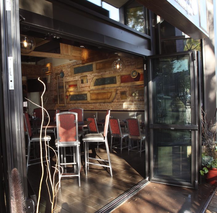 Glass retractable wall allowing the bar area to open to the lively street scene at Chili U.