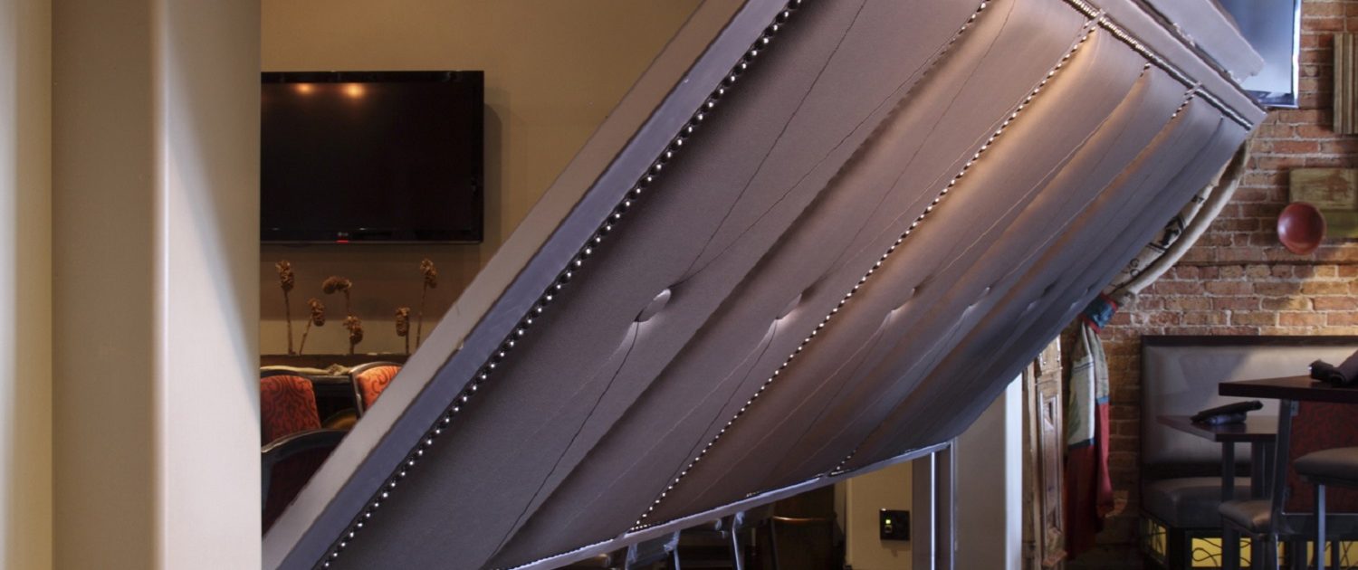 A clubby private dining room adjacent to the bar is accessed by a retractable steel and faux leather upholstered wall at Chili U.