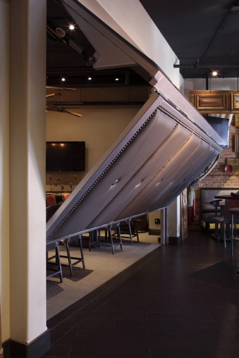 A clubby private dining room adjacent to the bar is accessed by a retractable steel and faux leather upholstered wall at Chili U.