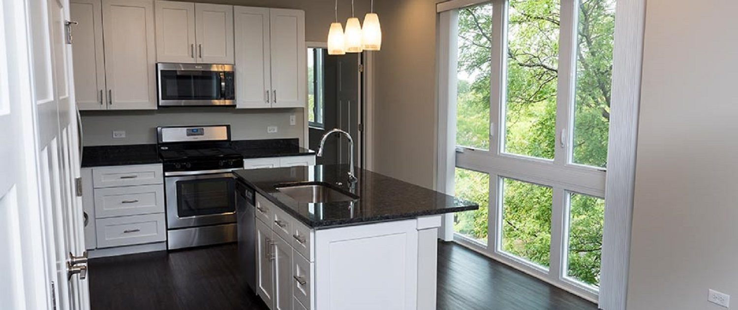 Northline Apartments in Libertyville, IL. View of the kitchen with floor to ceiling windows.