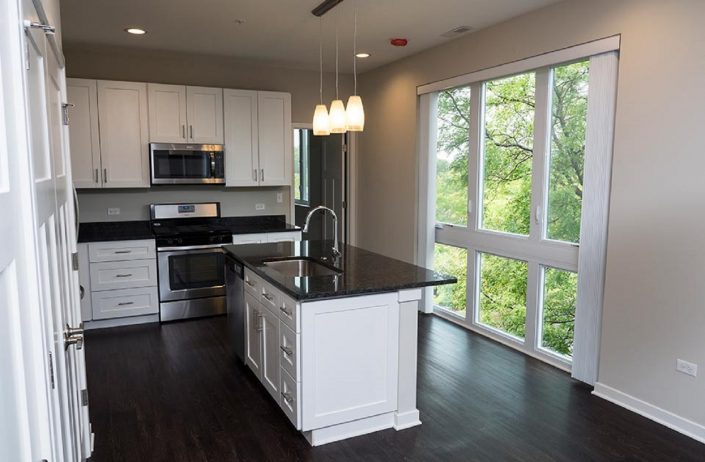Northline Apartments in Libertyville, IL. View of the kitchen with floor to ceiling windows.