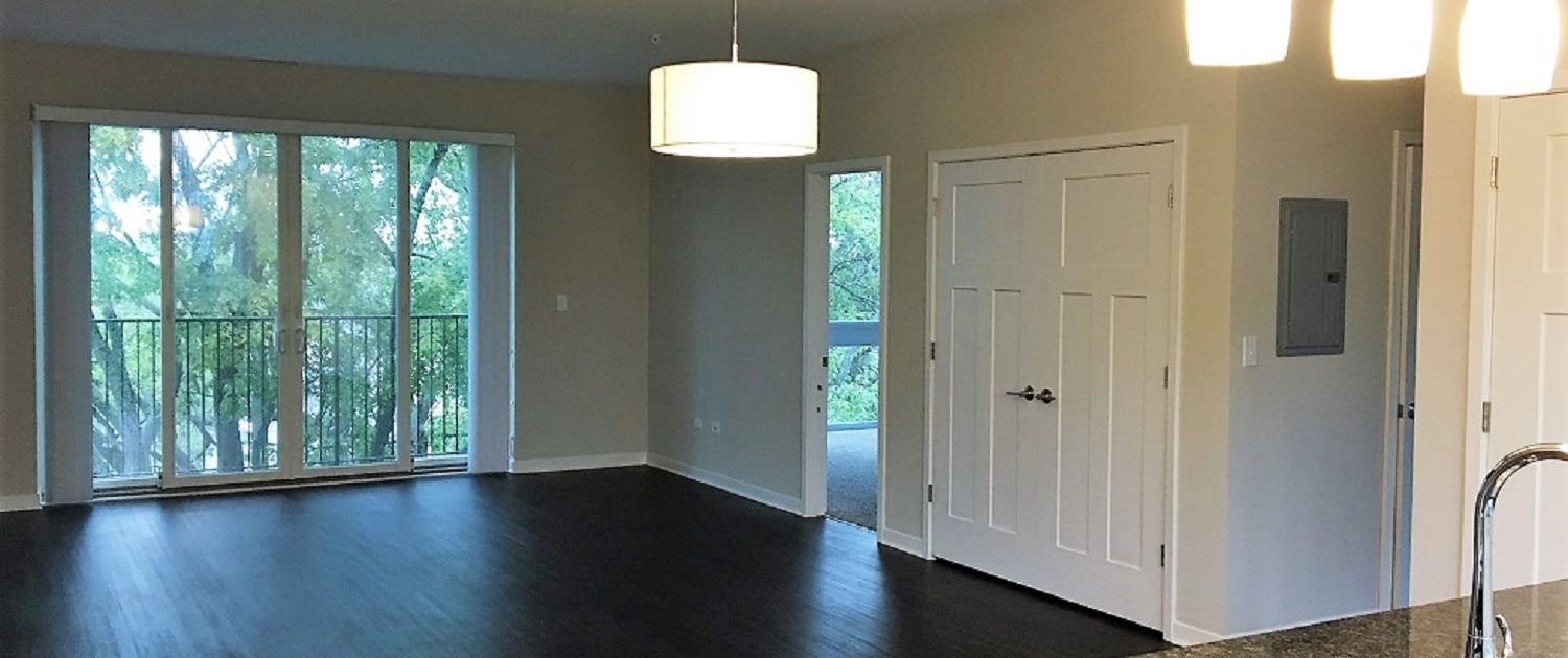 Northline Apartments in Libertyville, IL. View of the main living space and balcony.